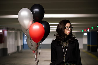 Woman with Balloons in Parking Garage