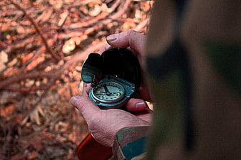 Hand Holding Vintage Compass In Autumn Forest