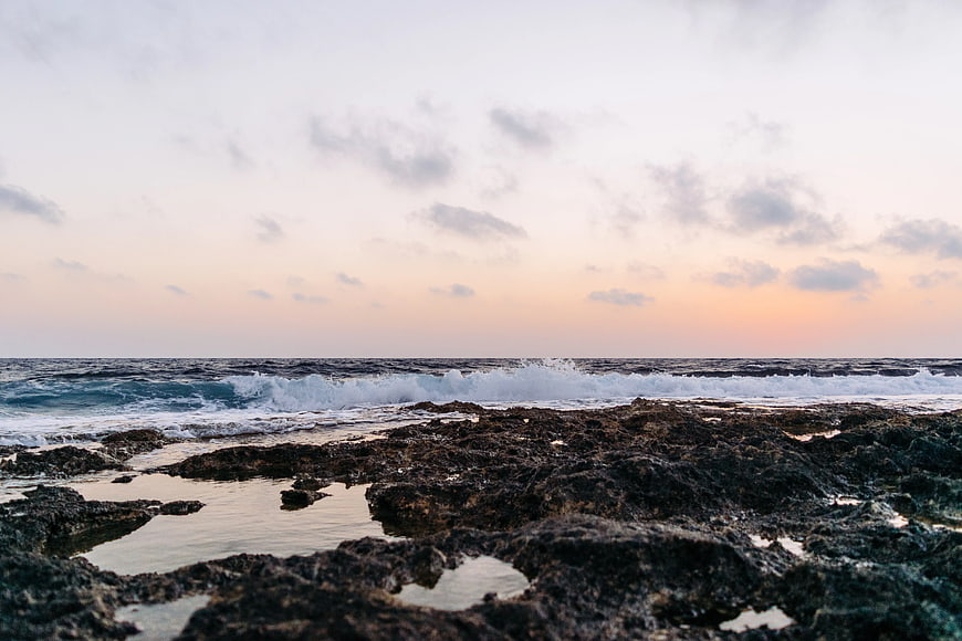 Rugged Rocky Coastline with Crashing Waves at Sunset