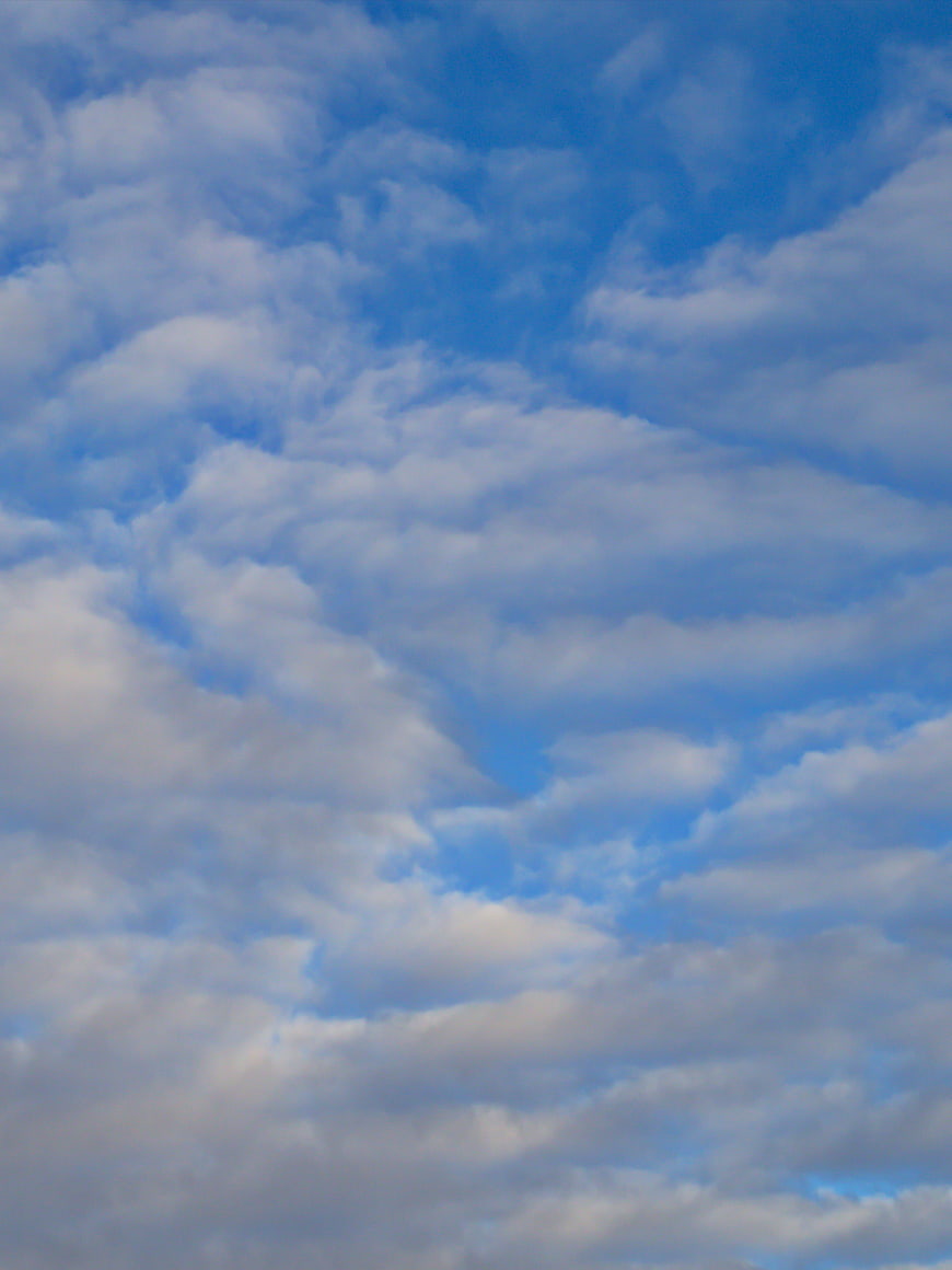 Blue Sky with Fluffy White Clouds Background