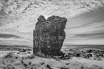 Ancient stone ruin standing in snowy winter landscape