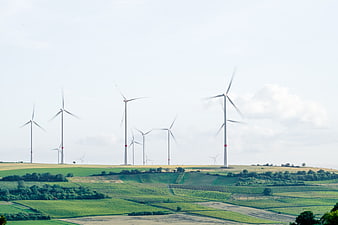 Wind turbines on green rolling hills landscape