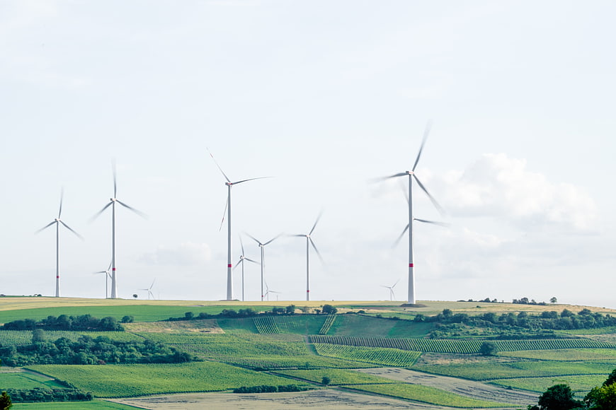 Wind turbines on green rolling hills landscape