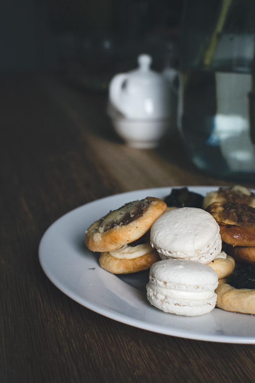 Assorted homemade pastries and macarons on a white plate