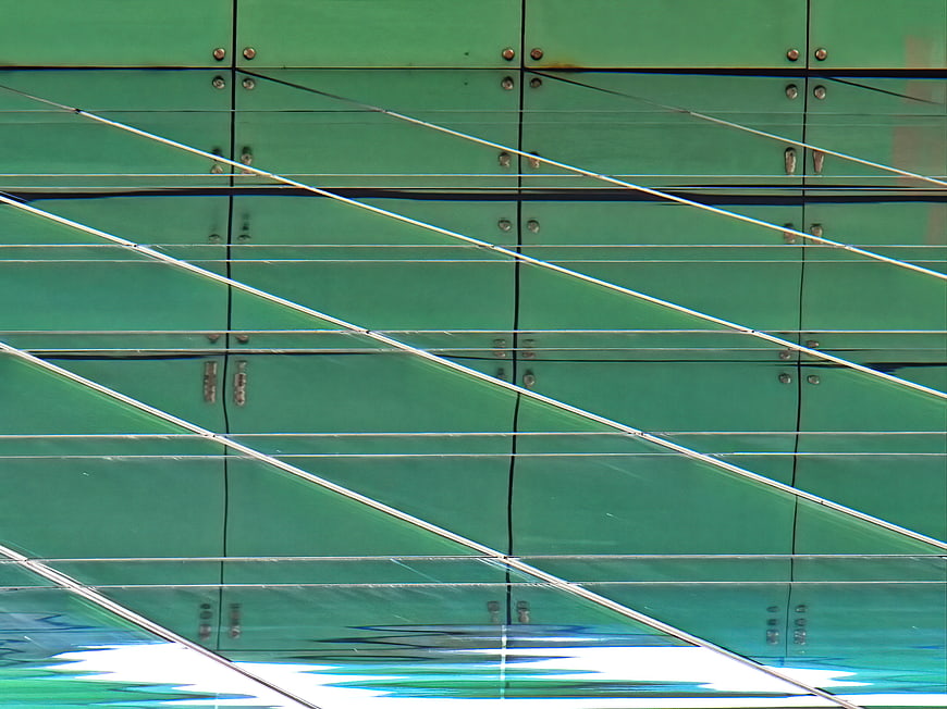 Abstract Green Glass Building Facade with Diagonal Lines