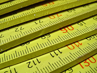 Close-up of yellow folding ruler with measurement markings