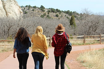 Three women hiking on a trail in nature