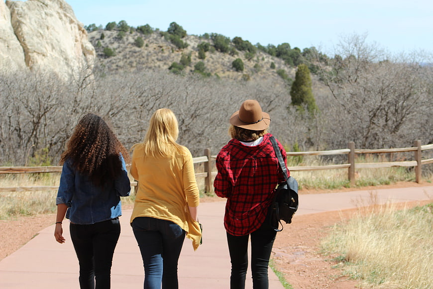 Three women hiking on a trail in nature