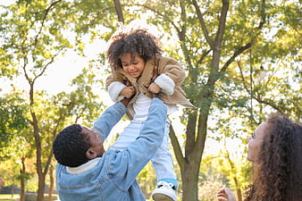 Happy African American Family Playing in Park