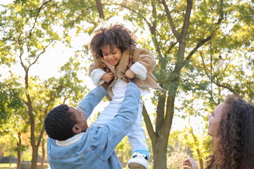 Happy African American Family Playing in Park