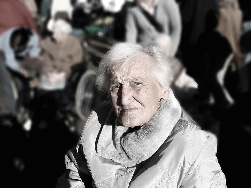 Portrait of elderly woman with white hair in winter coat