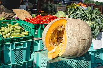 Fresh pumpkin and vegetables at an outdoor farmers market