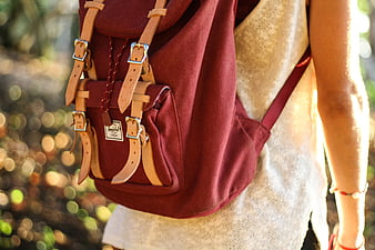 Woman Wearing Burgundy Canvas Backpack in Sunlight