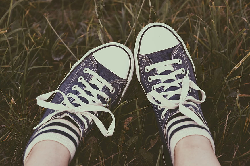 Blue Canvas Sneakers on Grass with Striped Socks