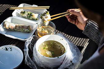 Vietnamese takeaway food with spring rolls and pho soup