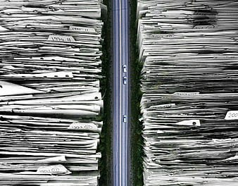 Aerial View of Road Flanked by Massive Stacks of Paper Documents