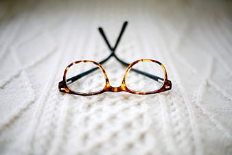 Tortoiseshell Eyeglasses on White Knitted Blanket