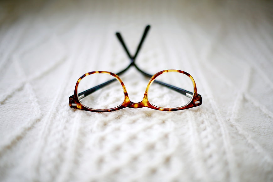Tortoiseshell Eyeglasses on White Knitted Blanket
