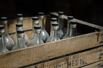 Vintage glass bottles in a rustic wooden crate