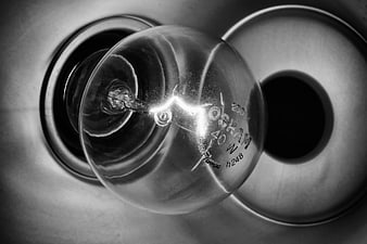 Close-up of vintage Osram light bulb in black and white