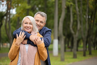 Happy Senior Couple Hugging in Autumn Park