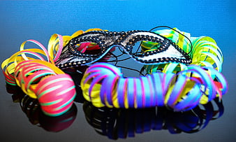 Colorful Carnival Mask with Neon Ribbons on Blue Background