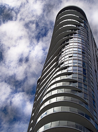 Low Angle View of Modern Curved Glass Skyscraper