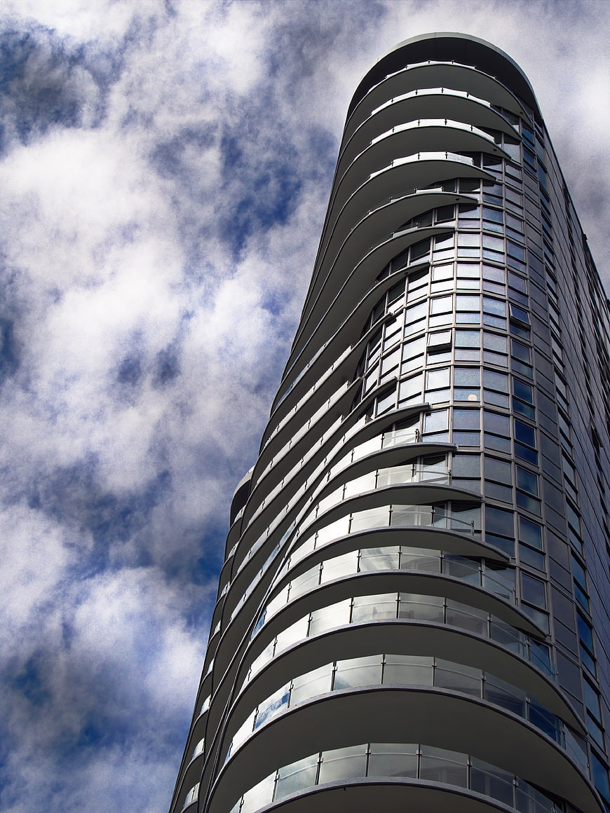 Low Angle View of Modern Curved Glass Skyscraper