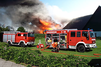 Firefighters battling large blaze with fire trucks