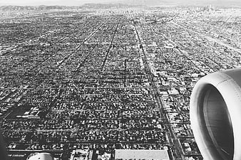 Black and white aerial view of Los Angeles from airplane window