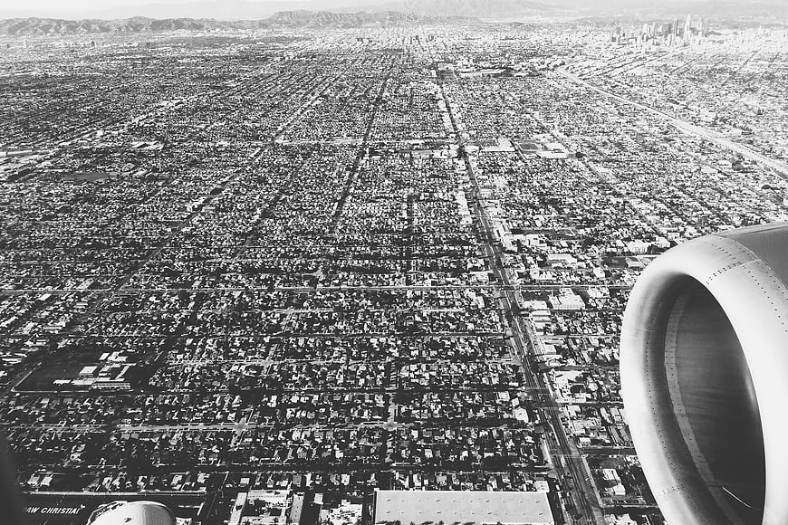 Black and white aerial view of Los Angeles from airplane window