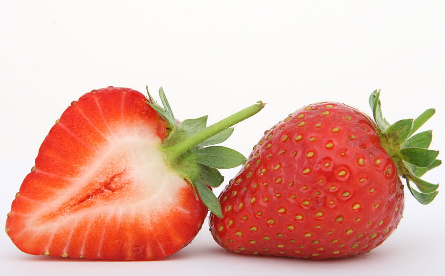Fresh Red Strawberry Cut in Half on White Background