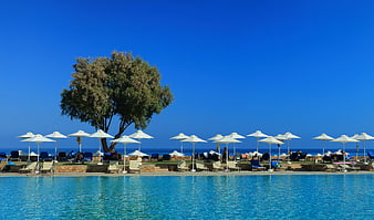 Luxury Resort Pool with White Umbrellas and Sea View