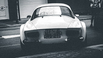 Rear view of vintage white sports car on street