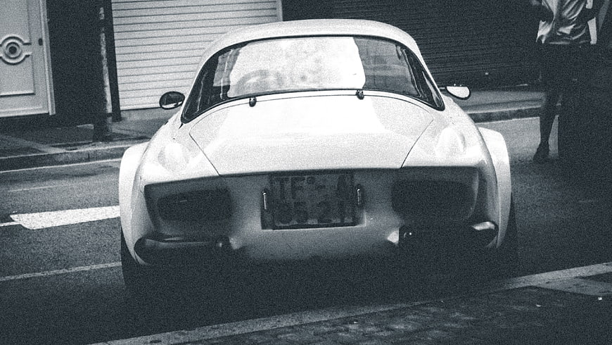 Rear view of vintage white sports car on street