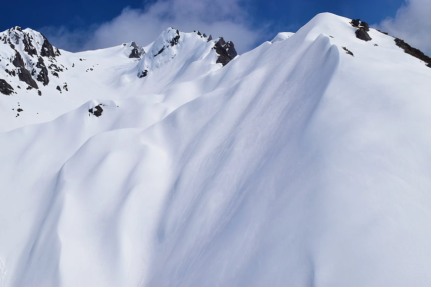 Snowy Mountain Slope with Blue Sky
