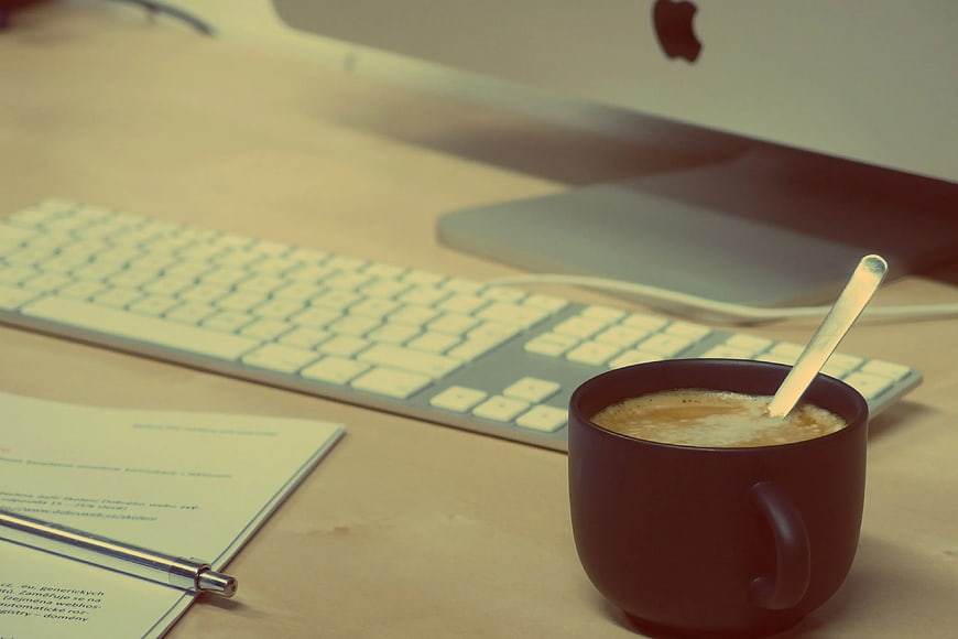 Coffee Mug on Desk with Keyboard and Computer