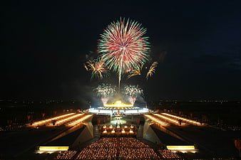 Grand Fireworks Display Over Illuminated Stadium at Night