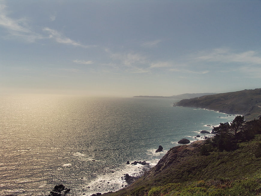 Sunlit Pacific Coastline with Rolling Hills and Ocean View