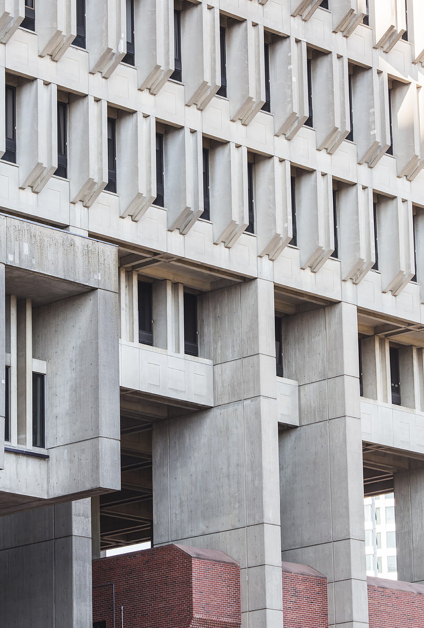 Modern Brutalist Concrete Building Facade with Geometric Windows