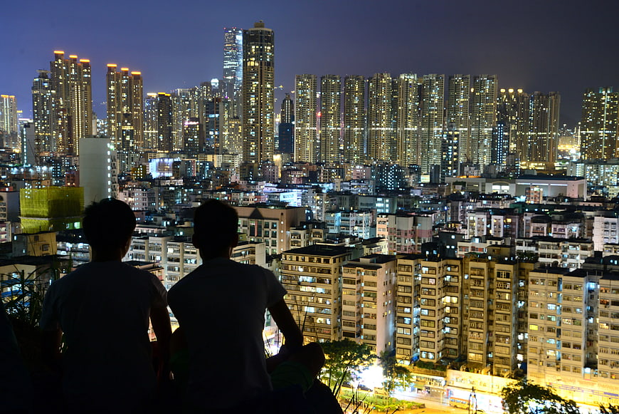 Silhouette of Two People Overlooking City Skyline at Night