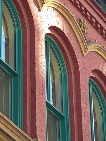 Pink Brick Building with Green Arched Windows