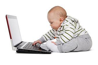 Baby Boy Sitting On White Background Using Laptop Computer