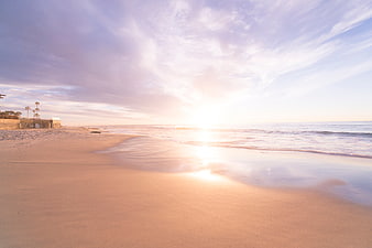 Serene Beach Sunrise with Soft Pink and Blue Sky