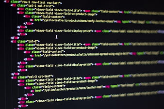 Close-up of HTML code on a dark computer screen