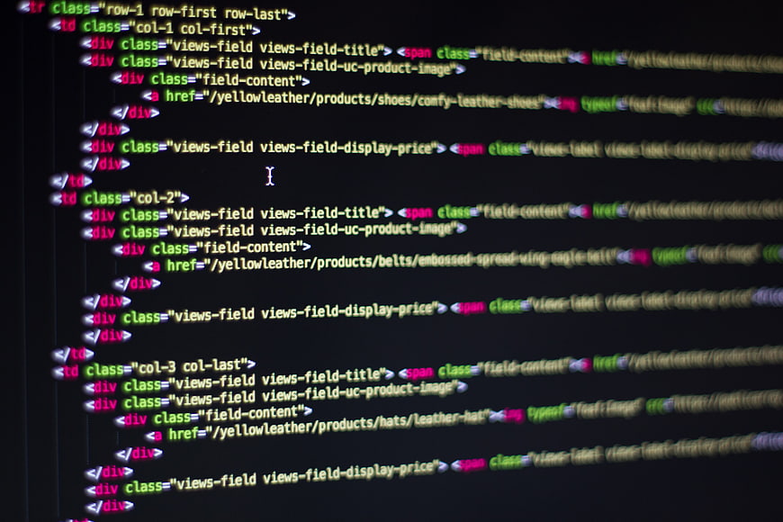 Close-up of HTML code on a dark computer screen