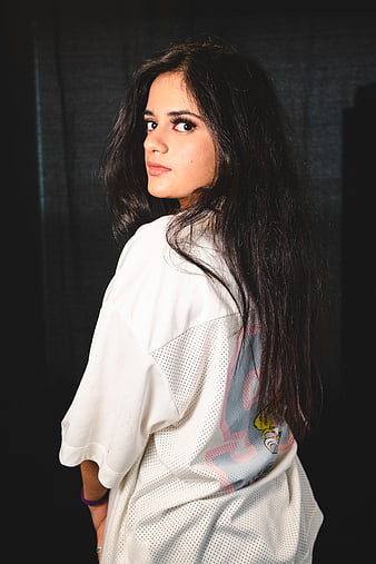 Young Woman in White Jersey Looking Back Over Shoulder