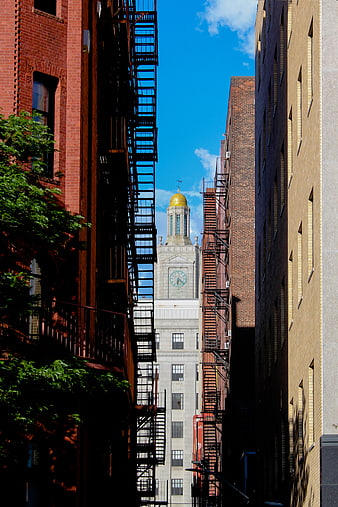 Urban Alleyway with Fire Escapes and Clock Tower