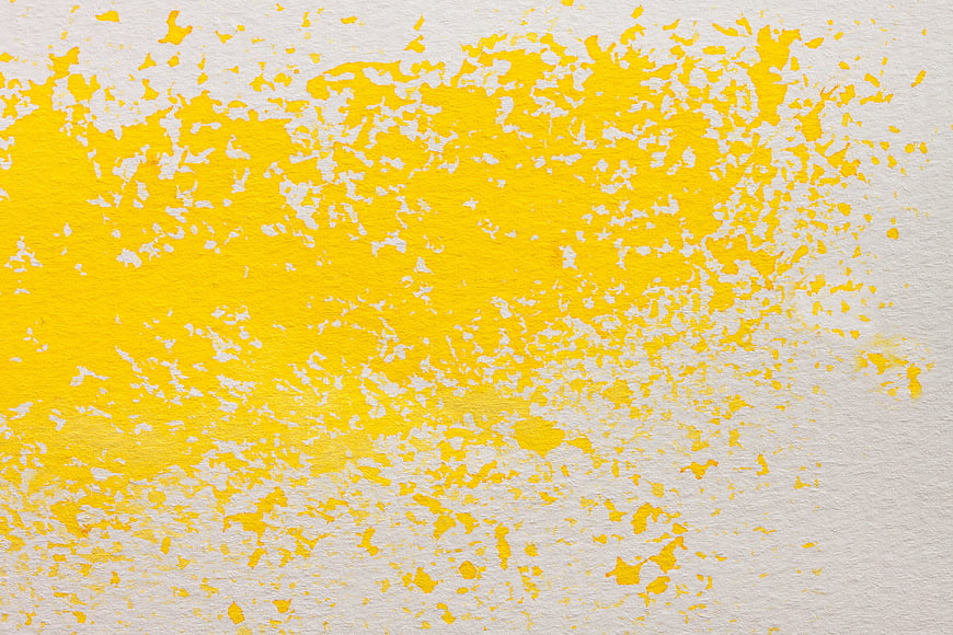 Yellow watercolor texture on white paper background