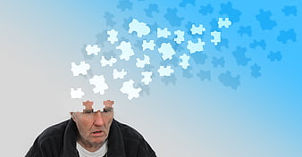Senior man with puzzle pieces escaping head representing memory loss